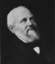 photo of Dr. Landesmann. White hair and beard, wearing a black suit and black bow tie.